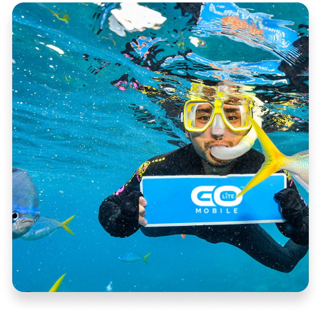 Scuba diver holding GoLite Mobile sign underwater